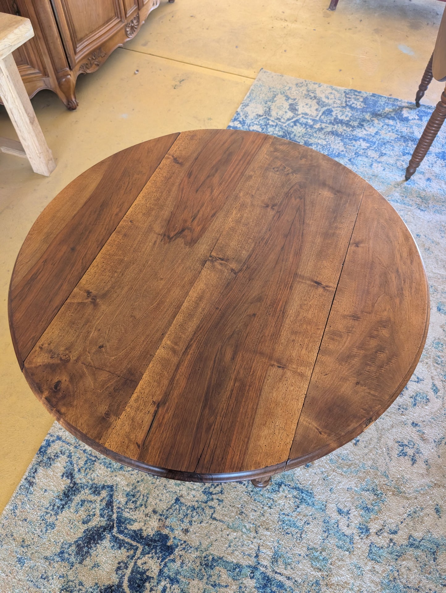 19th C. French walnut round table with fold down sides and turned legs on castors.