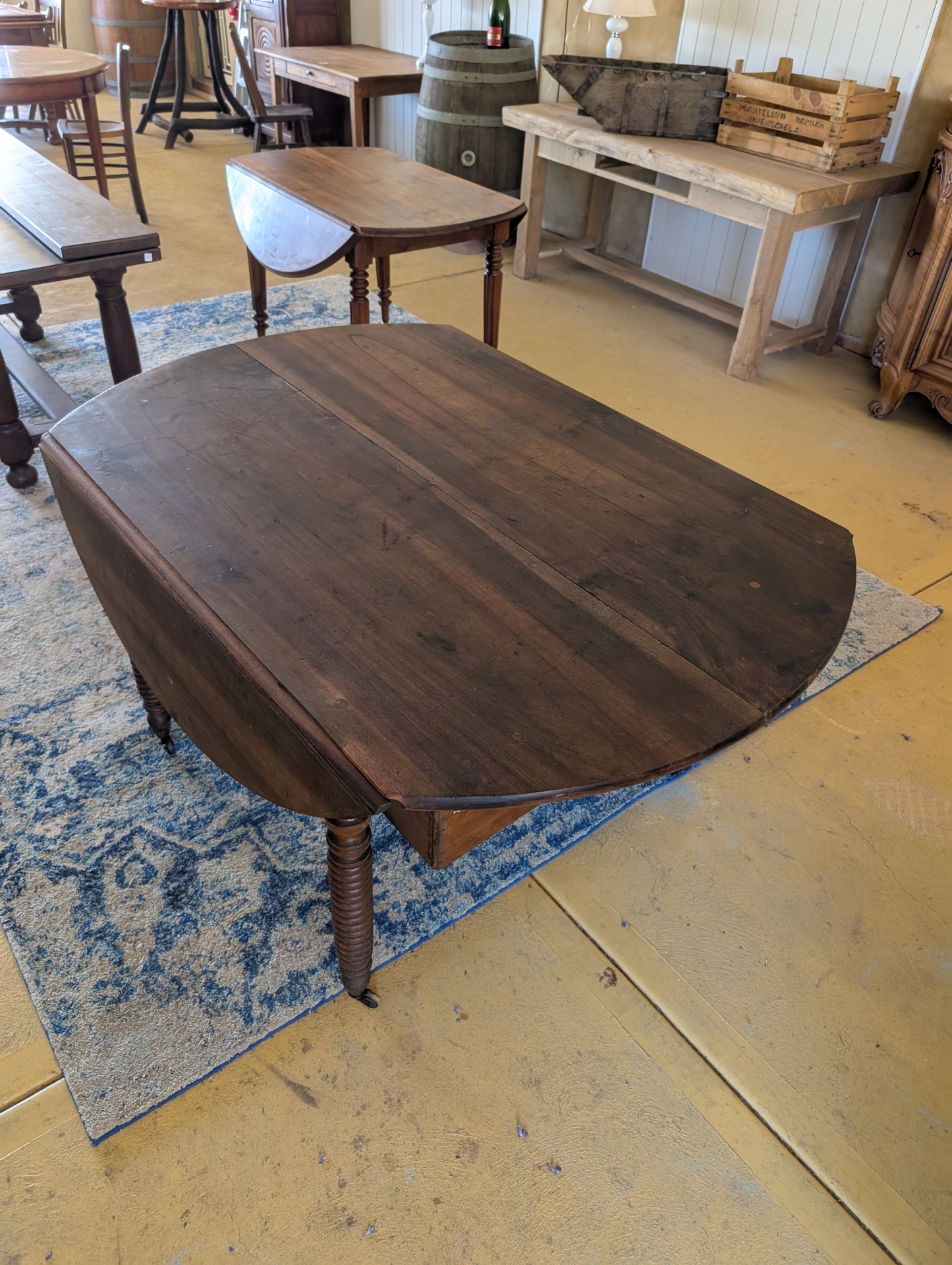 19th C. French walnut round table with fold down sides & turned legs.