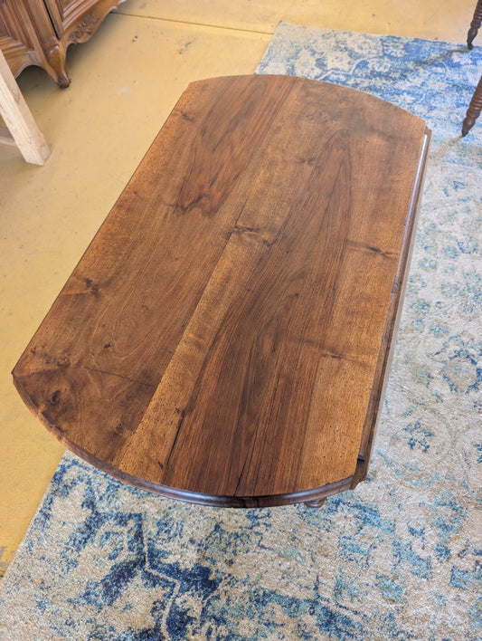 19th C. French walnut round table with fold down sides and turned legs on castors.