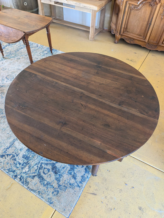 19th C. French walnut round table with fold down sides & turned legs.