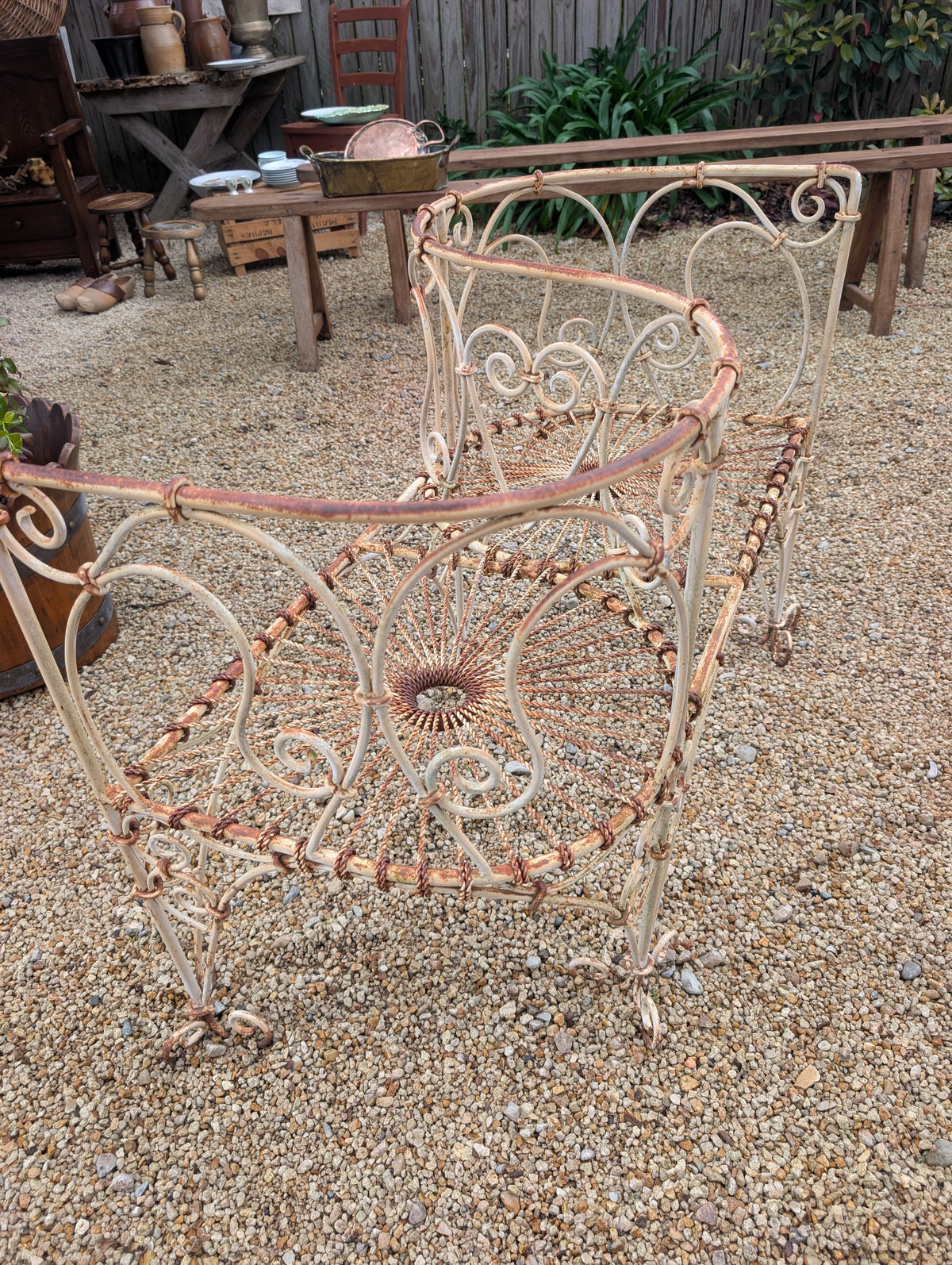 Wrought-iron love seat, mid C20th.
