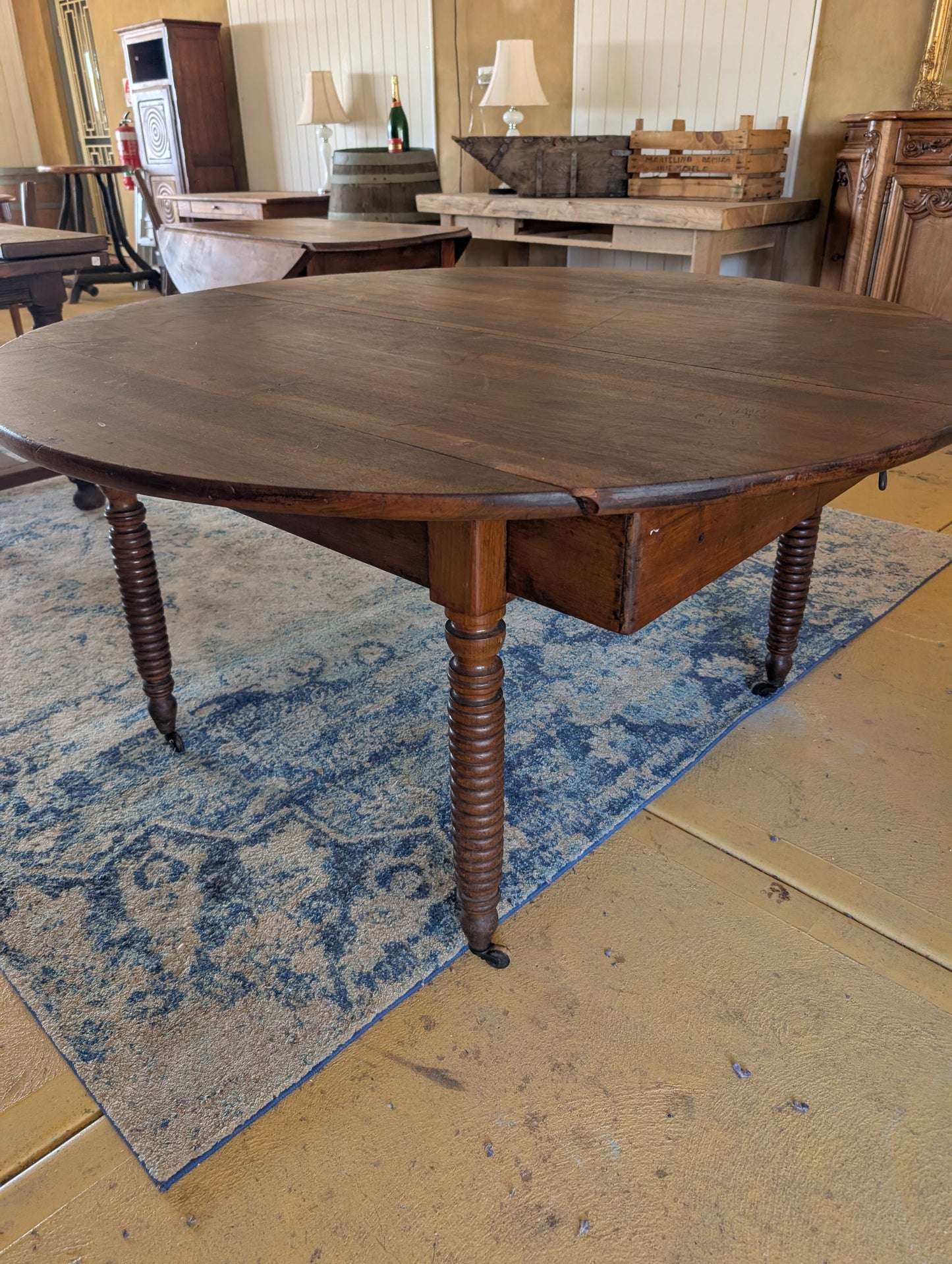 19th C. French walnut round table with fold down sides & turned legs.