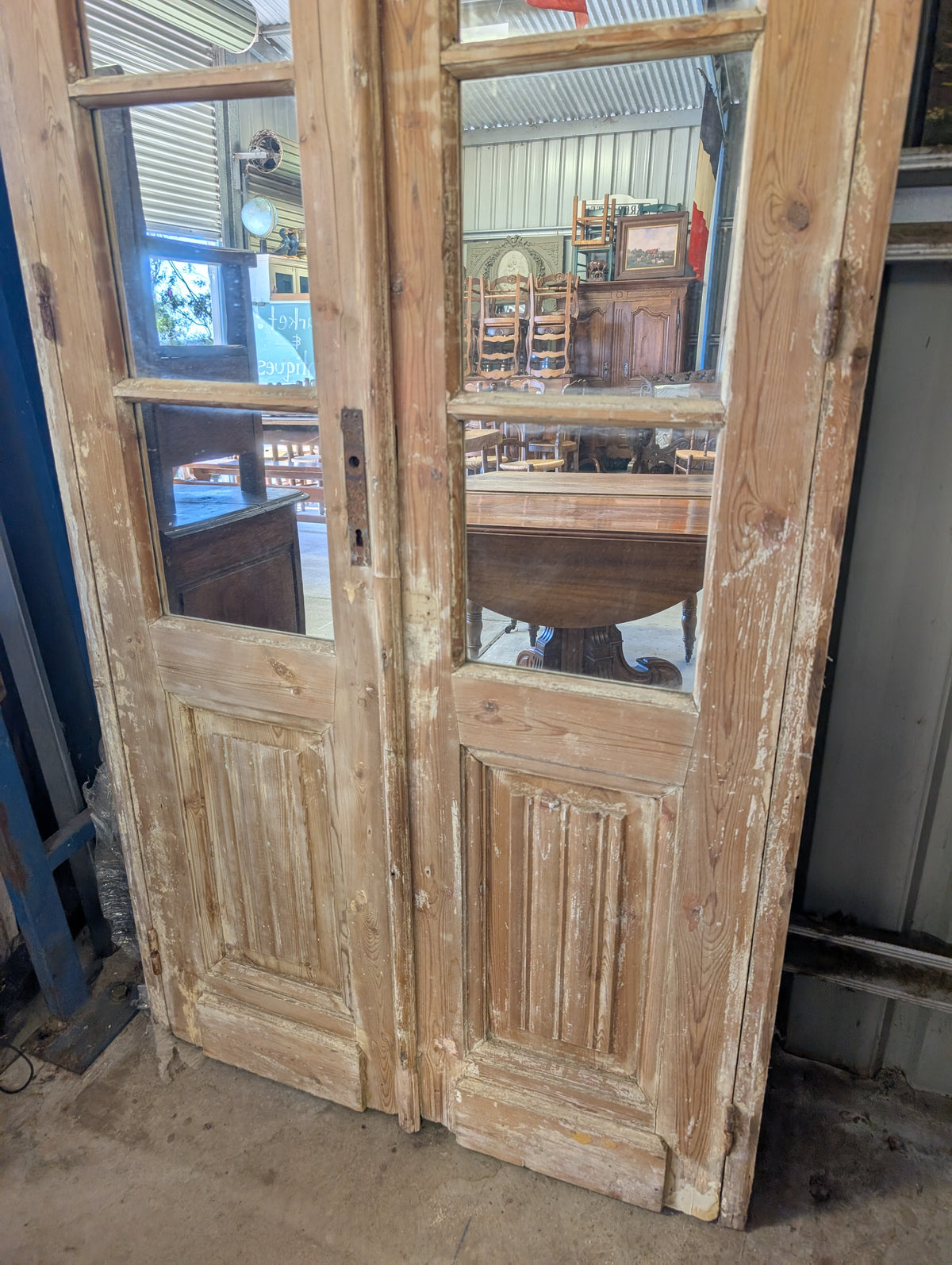 French antique French double doors with a matching top transom door with mirrors in.