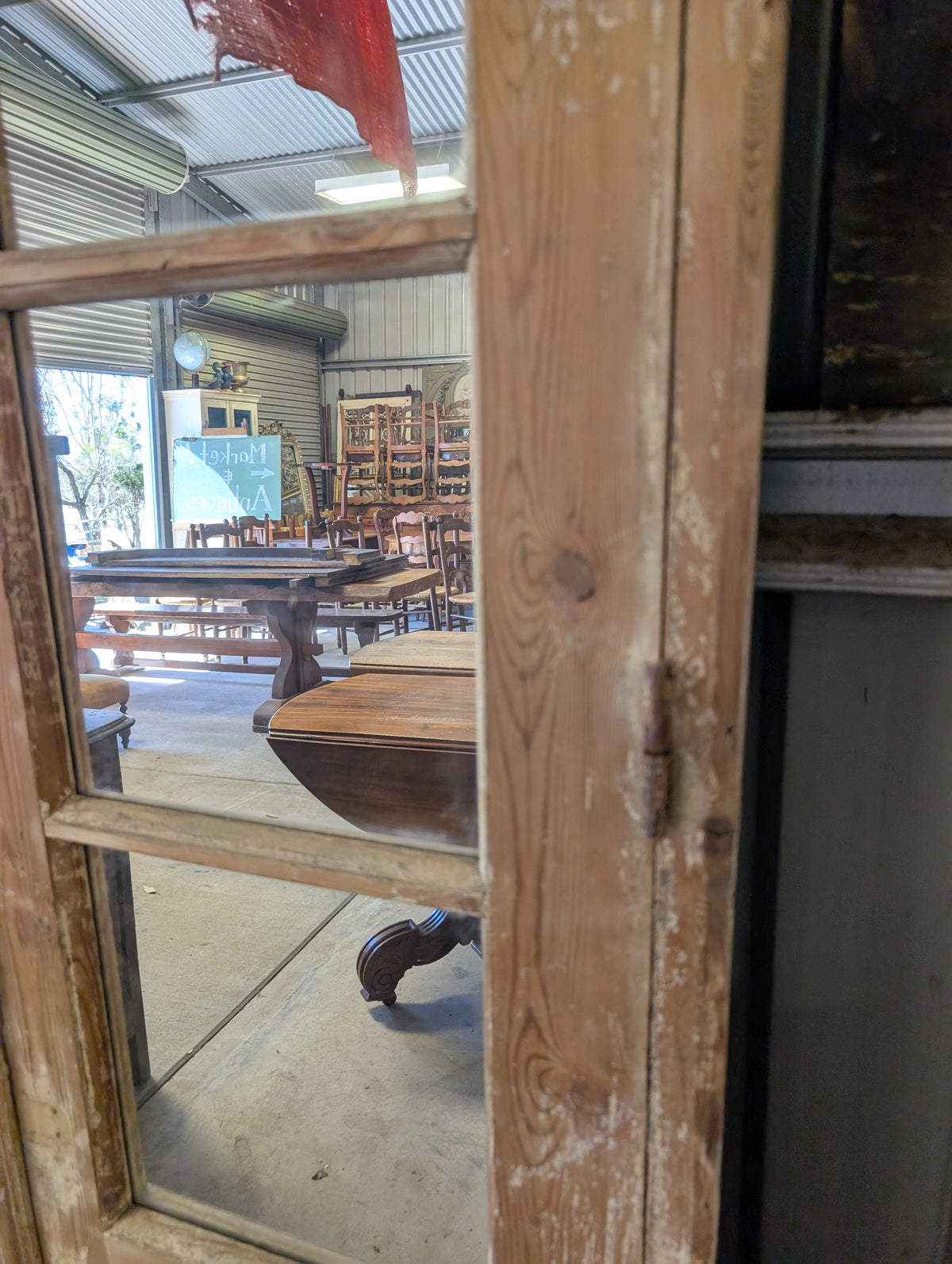 French antique French double doors with a matching top transom door with mirrors in.