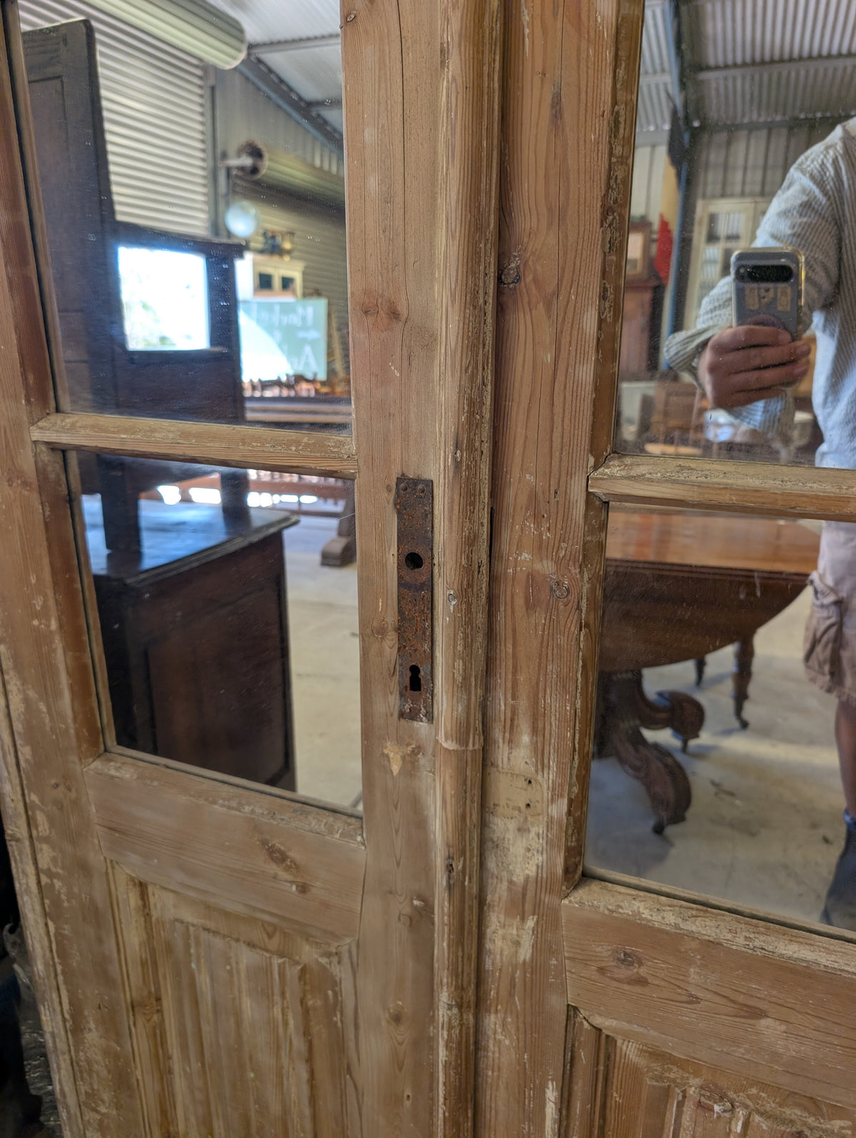 French antique French double doors with a matching top transom door with mirrors in.