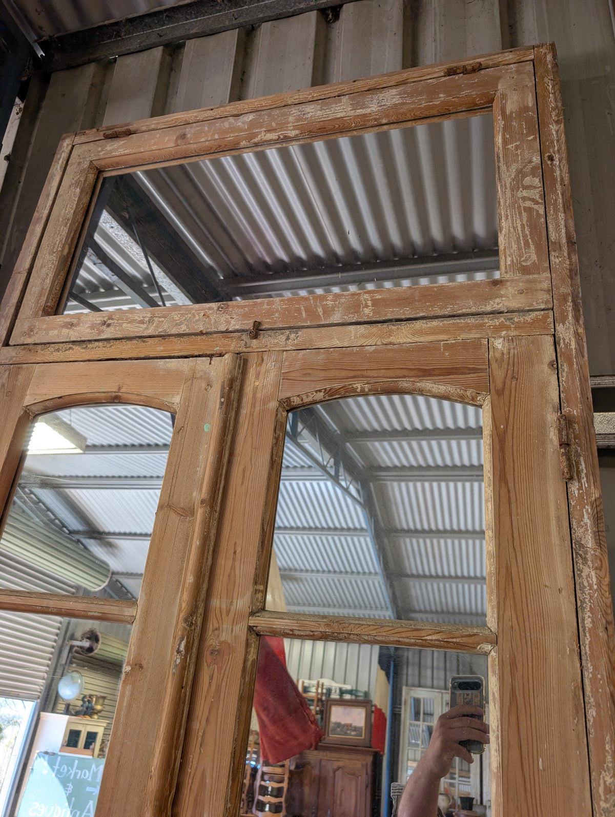 French antique French double doors with a matching top transom door with mirrors in.